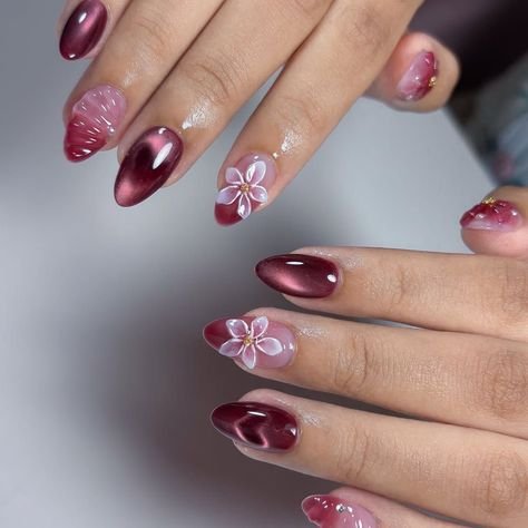 Plum Cat Eye Nails with a Floral Accent Nail for January Evenings