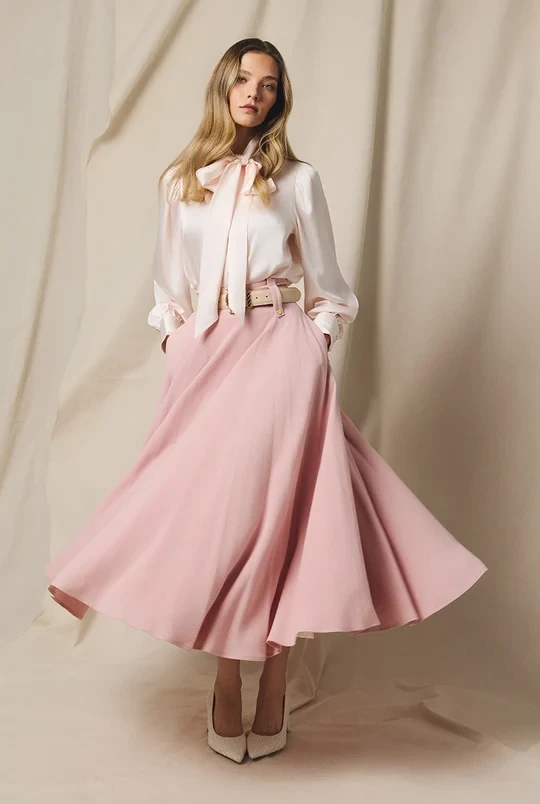 Dusty pink satin skirt outfit with elegant pointed flats and a slim leather belt