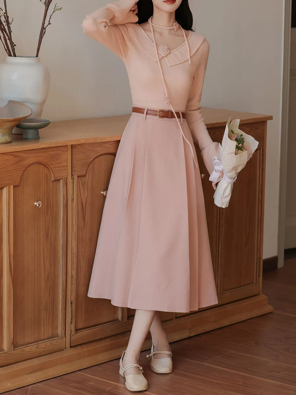 Soft pink sweater and A-line skirt outfit with kitten heels and a slim leather belt