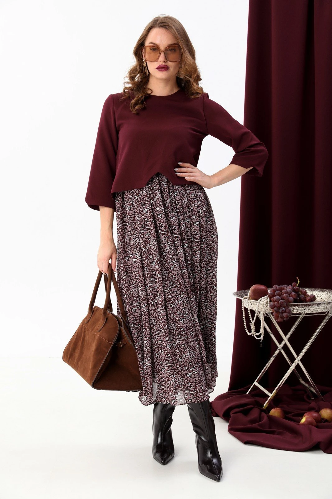 Burgundy blouse and tiered skirt outfit with block-heel ankle boots and statement earrings