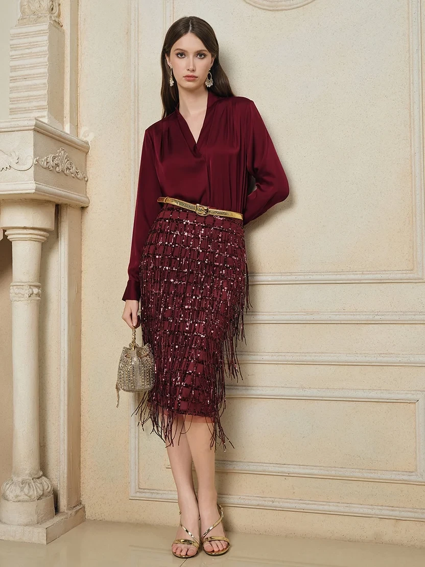Burgundy blouse and wrap skirt outfit with comfortable block heels and a beaded clutch