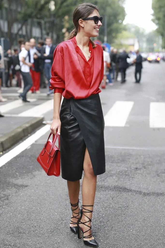 Deep red blouse and satin skirt outfit with black pointed heels and a chic crossbody bag