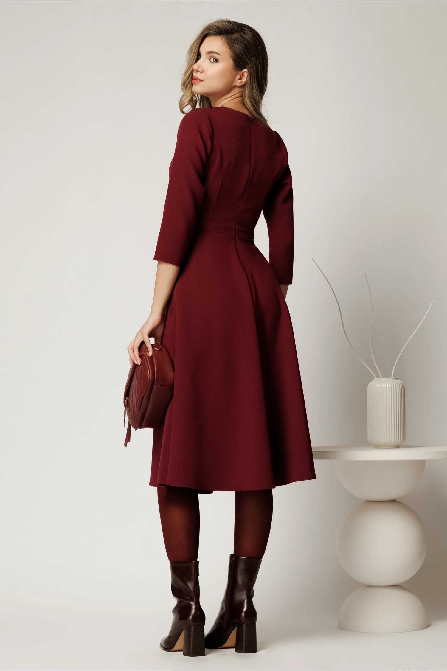 Wine A-line midi dress with block-heel ankle boots and a small structured clutch