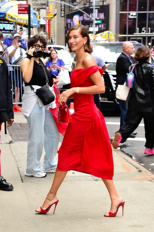 Bright red off-shoulder midi dress with kitten heels and a chic crossbody bag