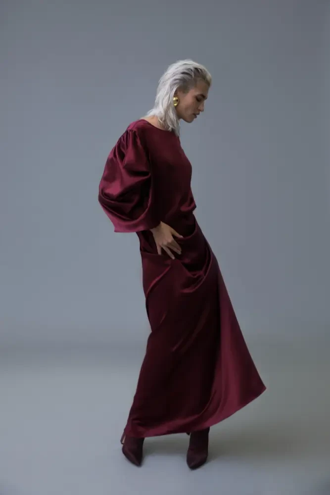 Scarlet satin long-sleeve dress with suede ankle boots and statement earrings