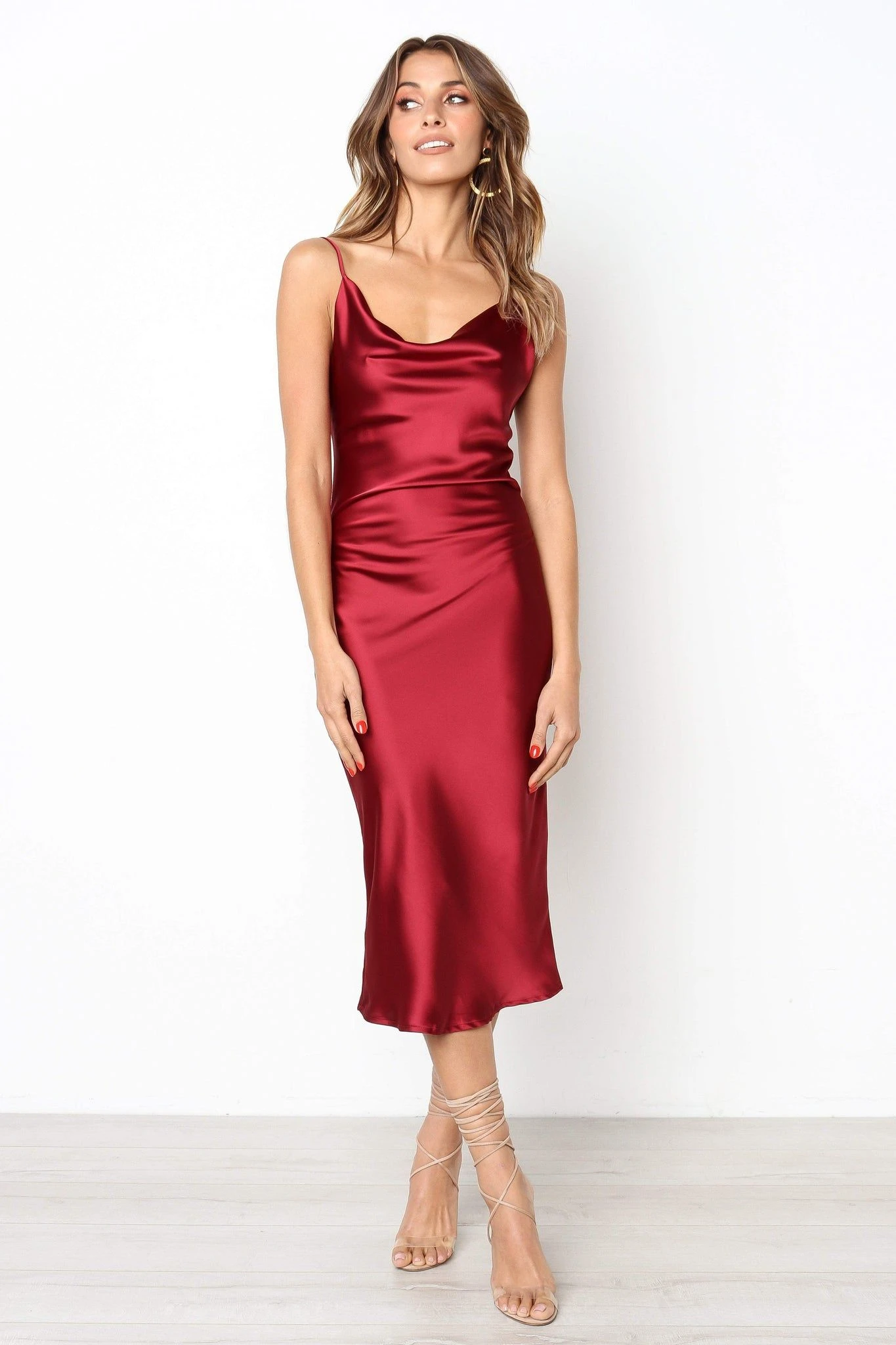 Cherry satin cowl-neck dress with black pointed heels and a silk scarf
