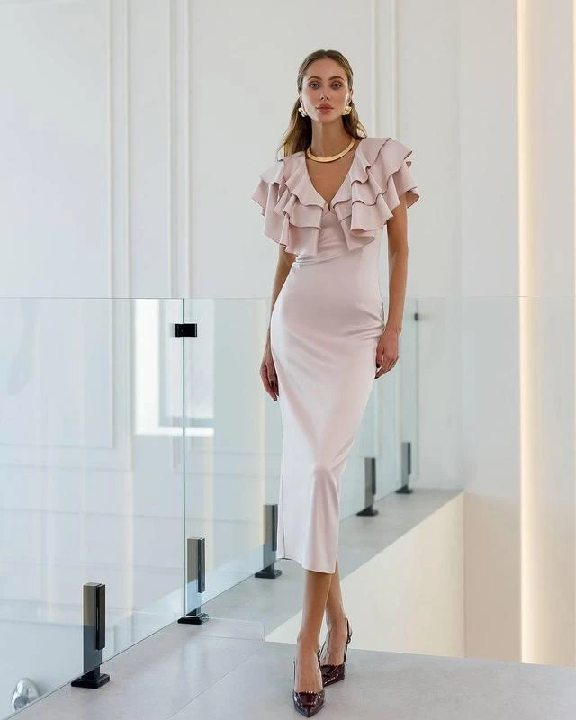 Pink ruffle V-neck dress with kitten heels and a delicate gold necklace