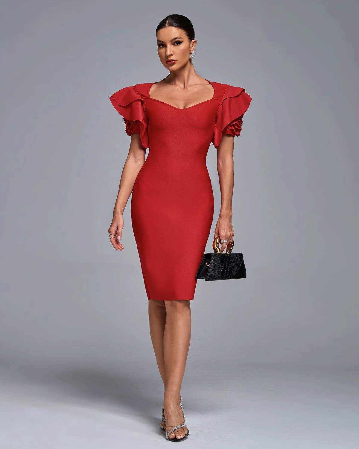 Red ruffle fit-and-flare dress with kitten heels and a small structured clutch