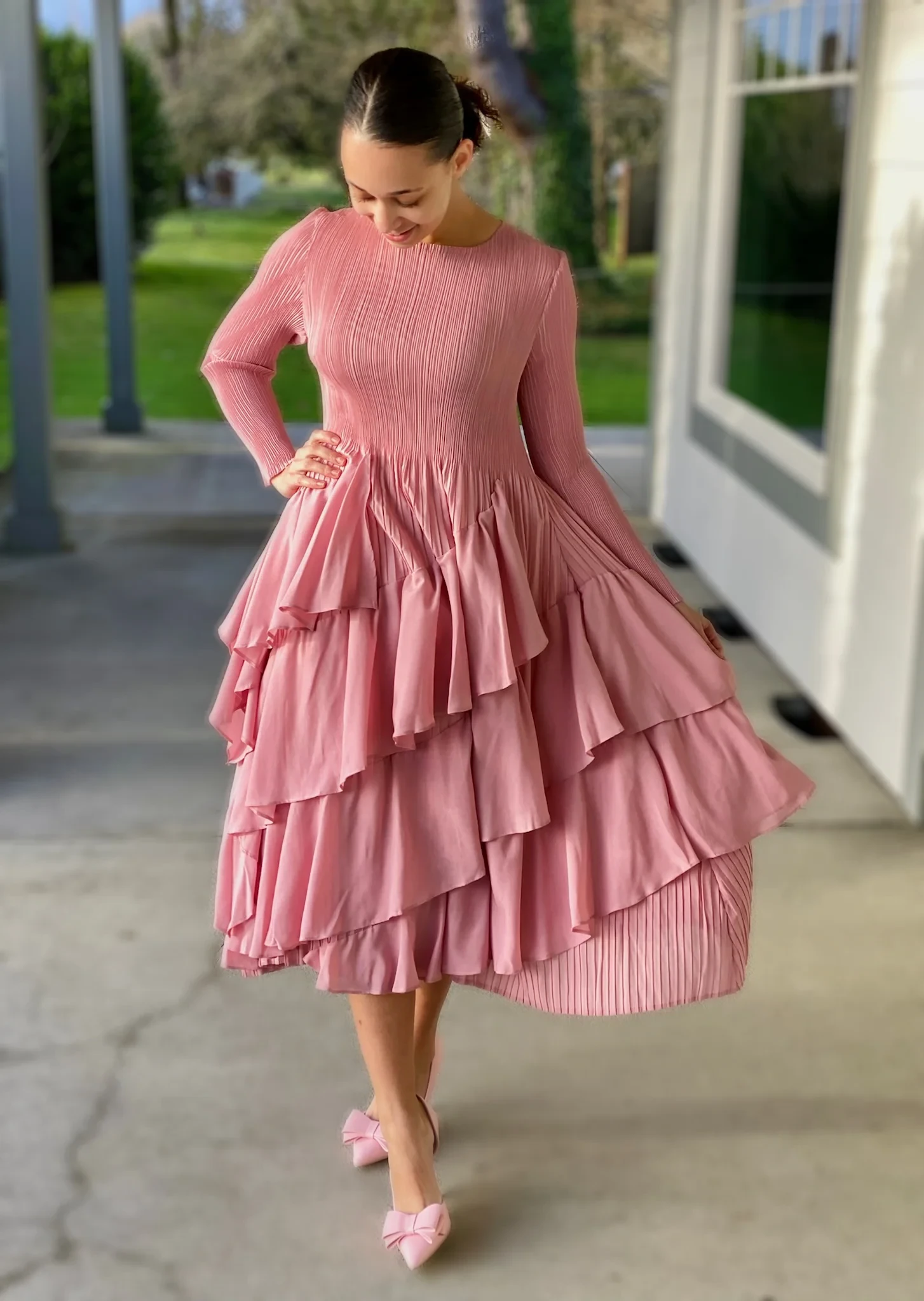 Pink ruffle tiered dress with pointed mules and a pearl bracelet