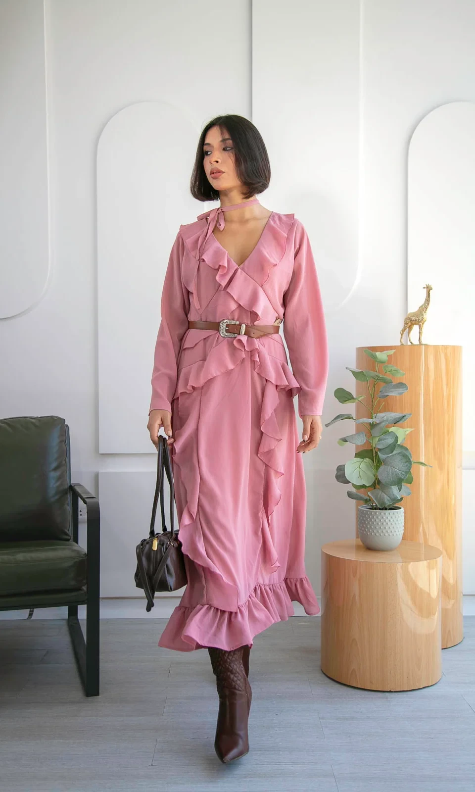 Pink ruffle tiered dress with leather ankle boots and a slim leather belt