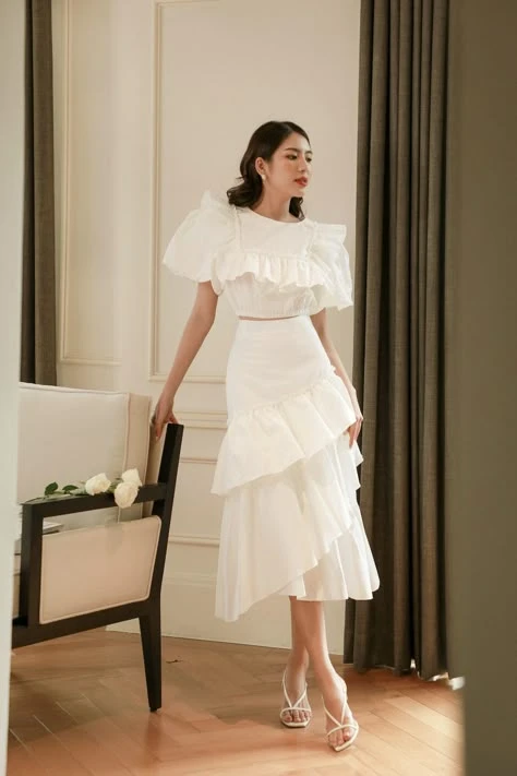 Ivory ruffle satin skirt outfit with comfortable block heels and a delicate gold necklace