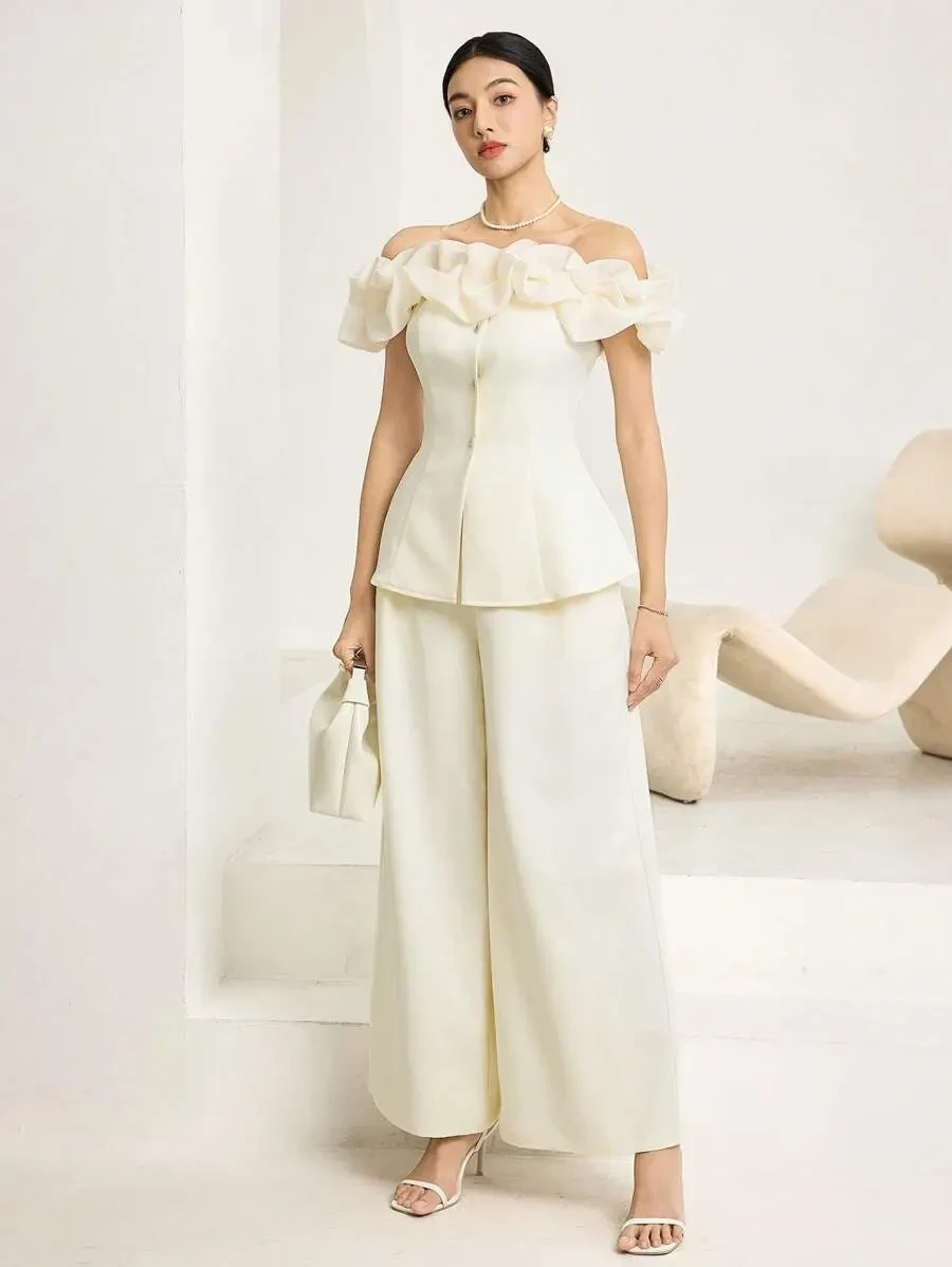 Cream ruffle sleeve top and satin trouser outfit with pointed mules and a pearl bracelet