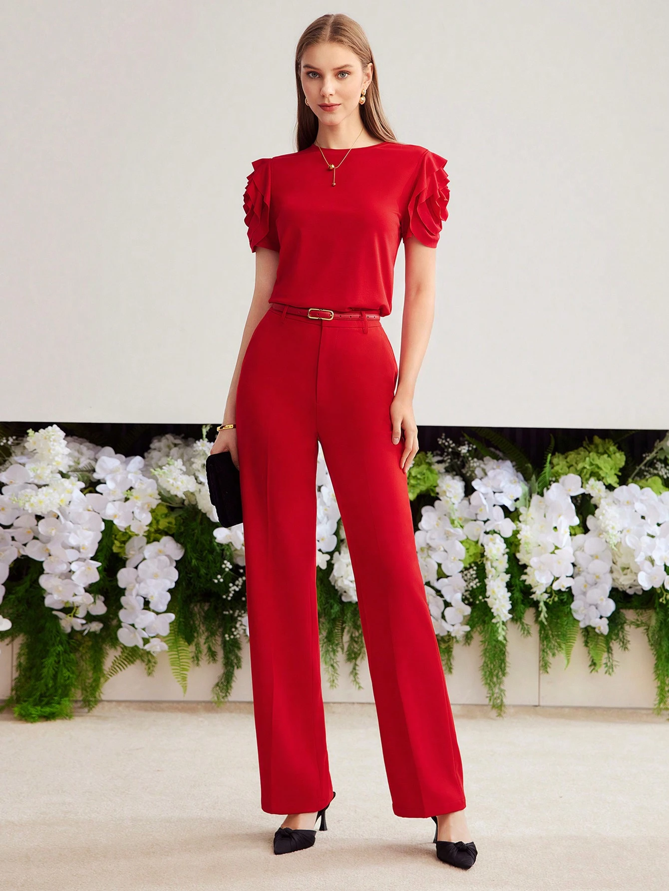 Red ruffle sleeve top and trouser outfit with low-heeled pumps and a slim leather belt