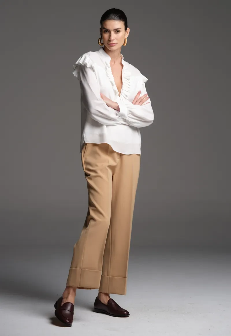 White ruffle sleeve top and straight trouser outfit with smart loafers and silver drop earrings