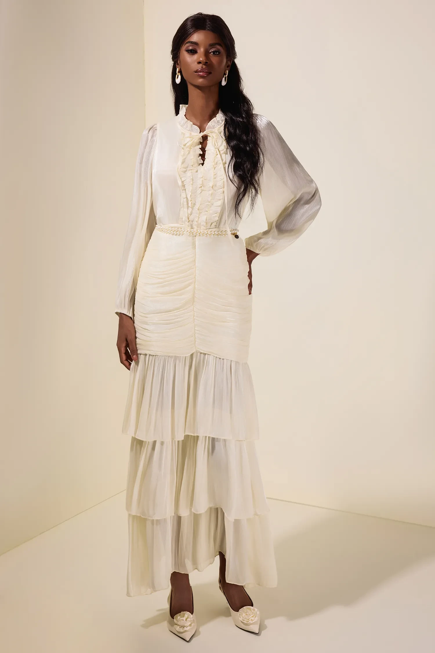 Ivory ruffle sleeve top and skirt outfit with elegant pointed flats and a slim leather belt