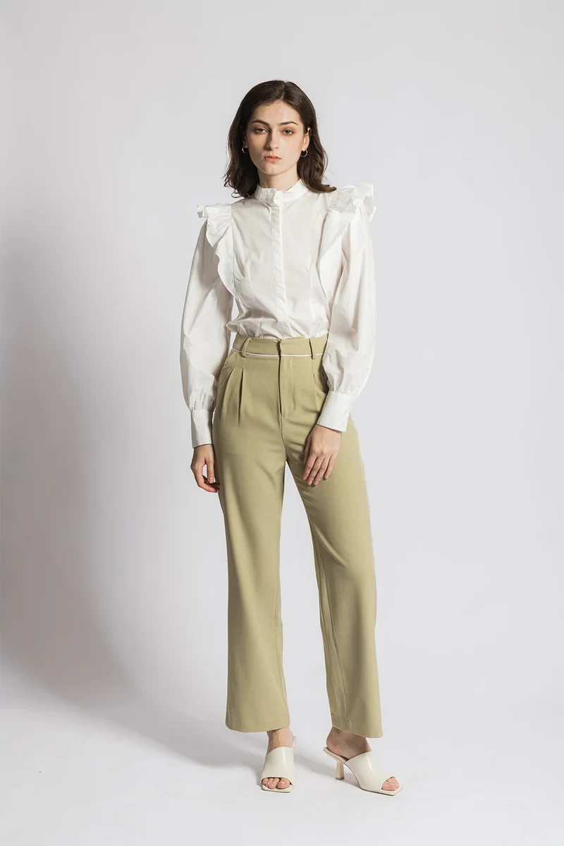 White ruffle sleeve top and straight trouser outfit with comfortable block heels and a slim leather belt