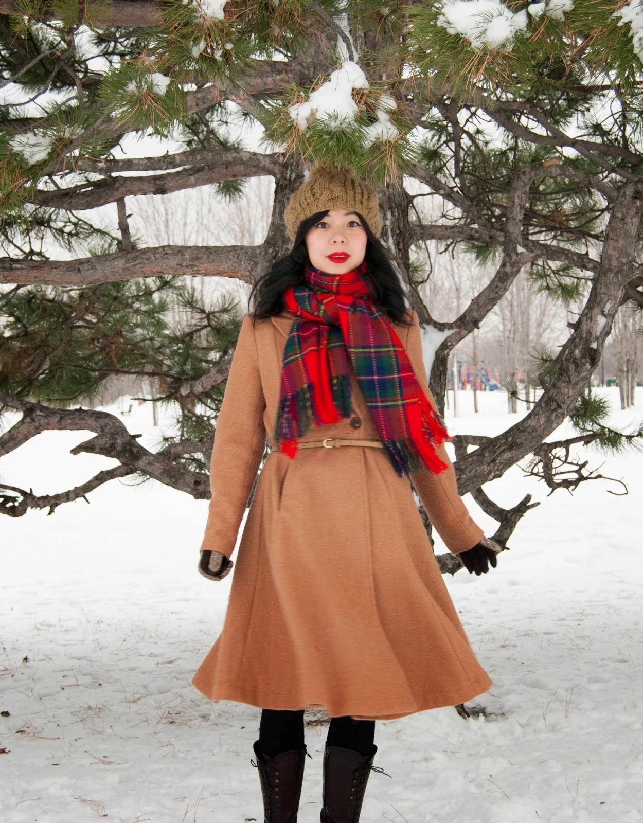 30 Scarf and Coat Layering Outfits for Snowy Walks That Are Chic, Warm and Elegant 13 Camel Wool Coat with a Red Plaid Scarf with Blue Jeans and Brown Knee-high Boots