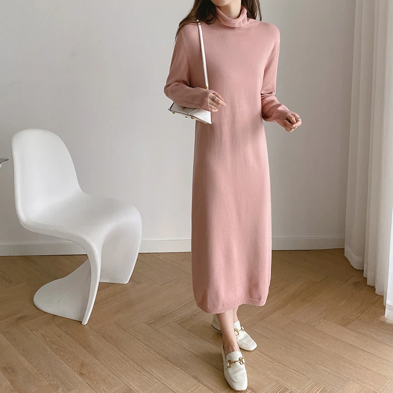 Soft pink knit dress outfit with smart loafers and a small structured clutch