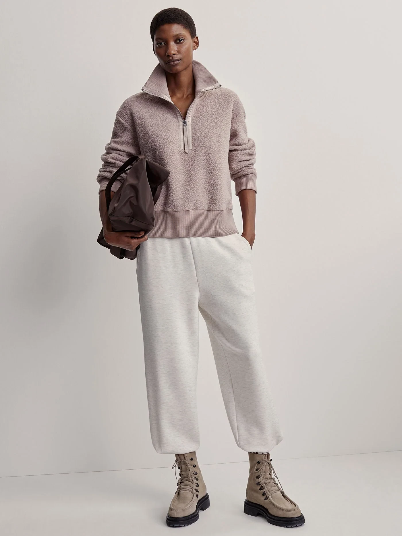 Dusty soft pink fine knit outfit with tailored trousers, suede ankle boots and a silk scarf
