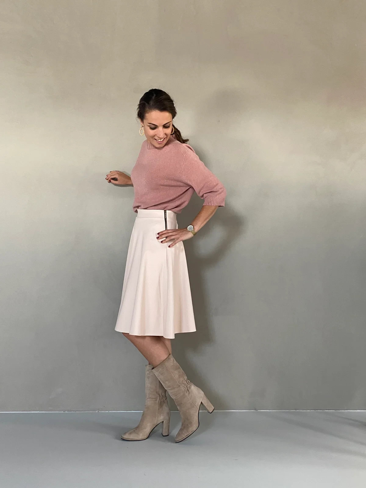 Dusty soft pink knit and skirt outfit with suede ankle boots and silver drop earrings