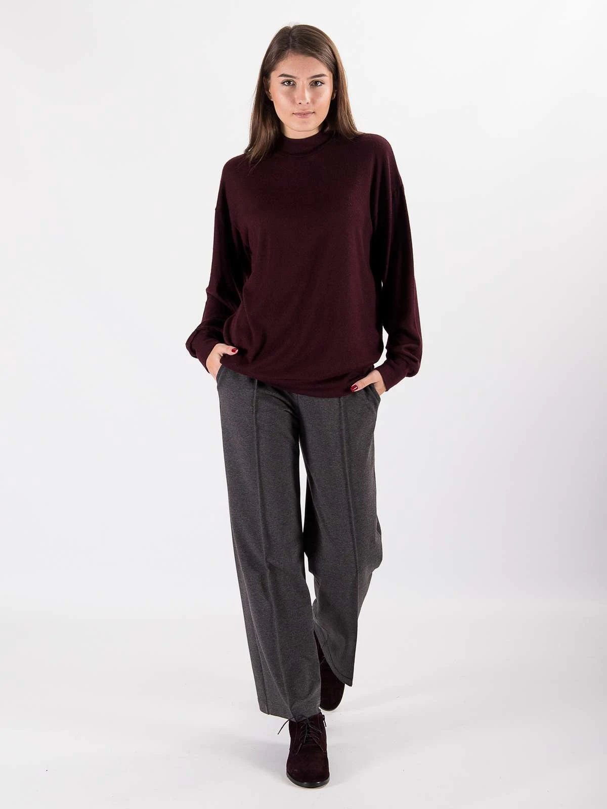 50 Thermal Layering Outfits for Cold January Days That Are Chic, Warm and Elegant 7 White Thermal Top under a Burgundy Knit Sweater with Grey Trousers and Burgundy Ankle Boots
