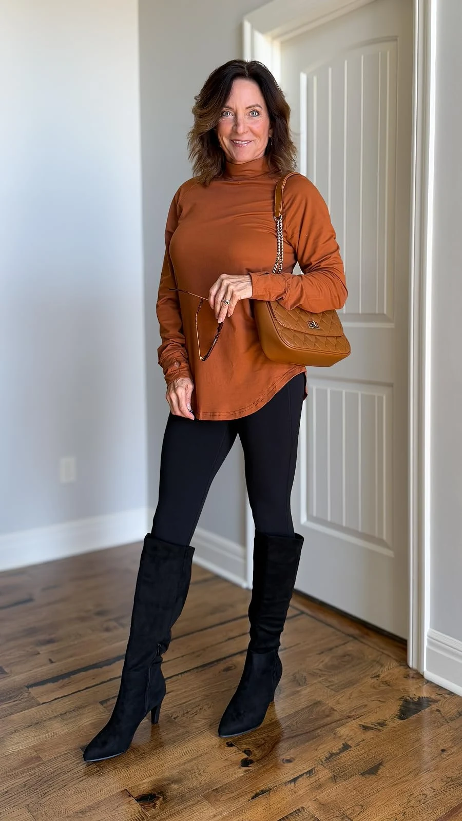 50 Thermal Layering Outfits for Cold January Days That Are Chic, Warm and Elegant 24 Grey Thermal Top under a Rust Knit Sweater with Black Leggings and Black Knee-high Boots