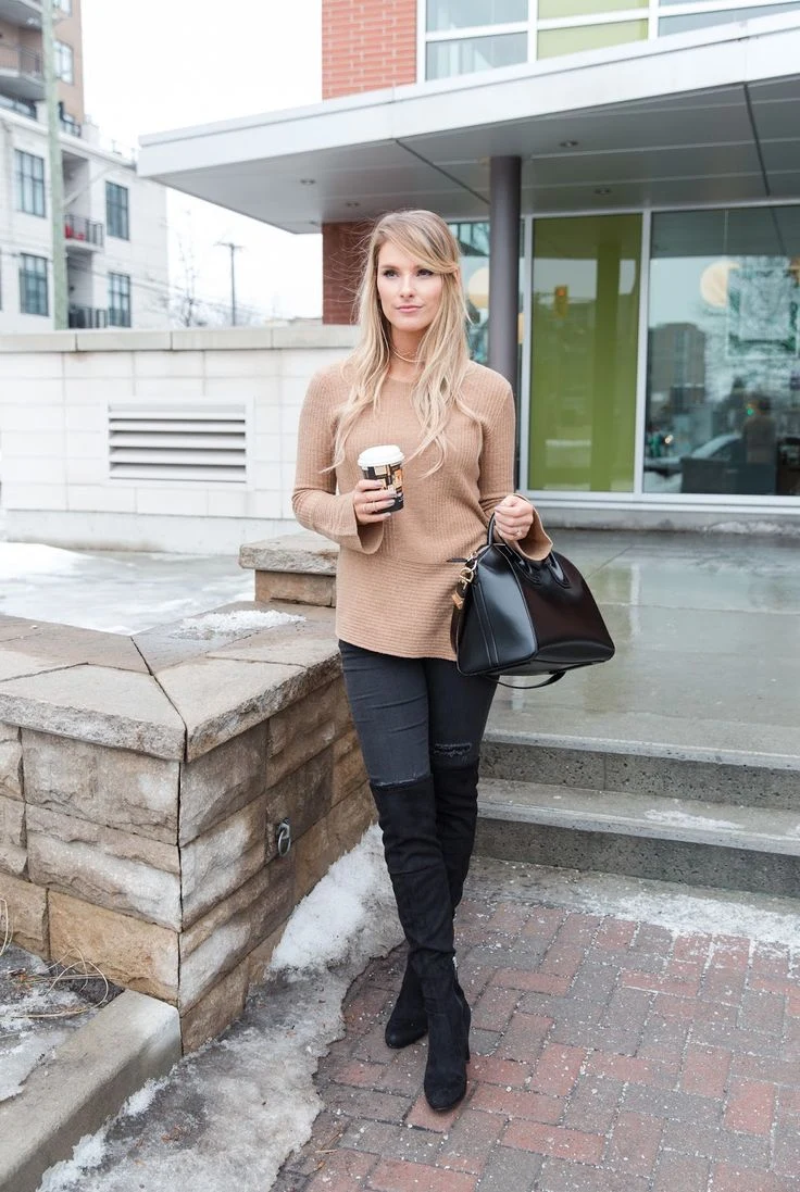 50 Thermal Layering Outfits for Cold January Days That Are Chic, Warm and Elegant 40 Black Thermal Top under a Camel Chunky Knit Sweater with Blue Jeans and Black Knee-high Boots