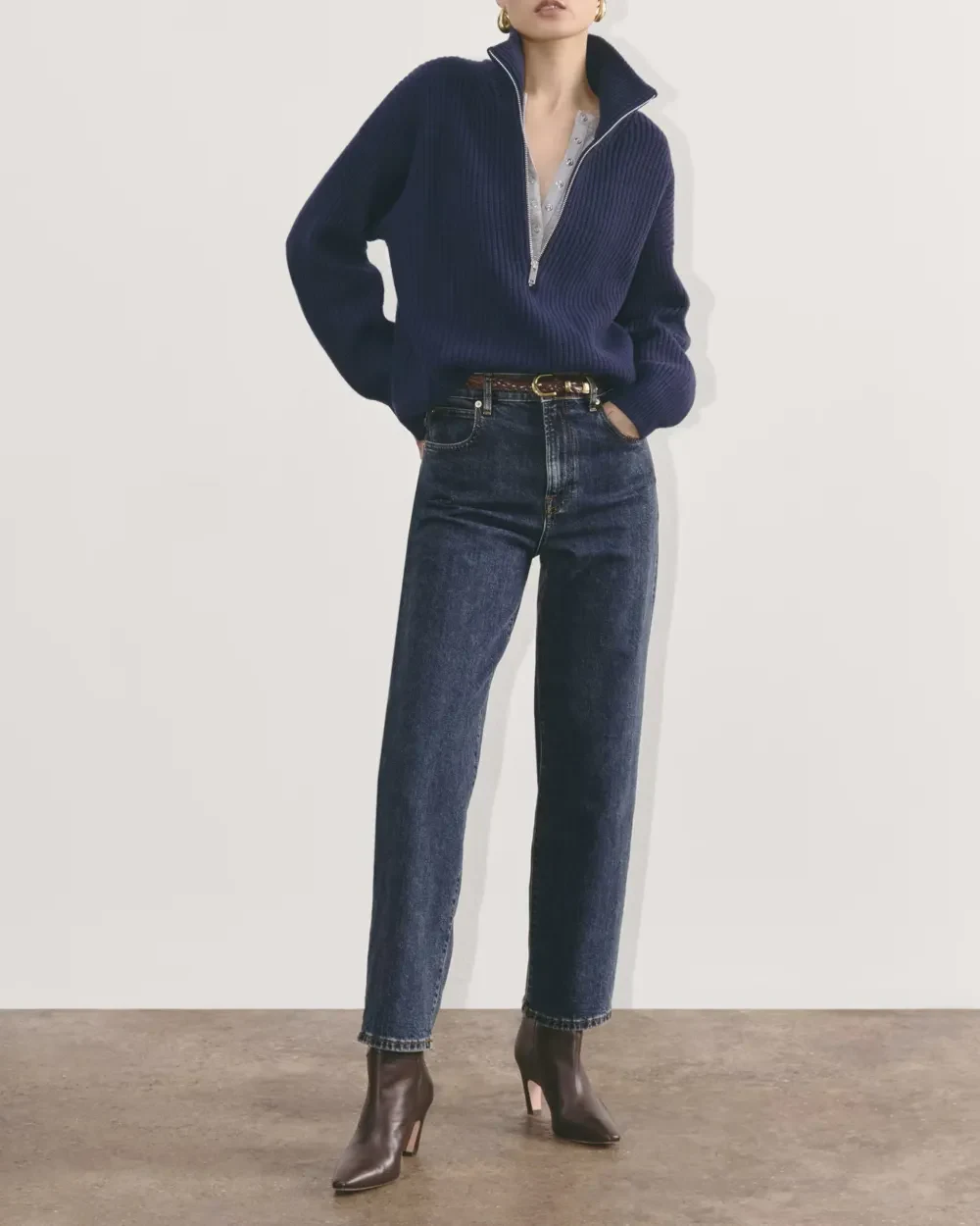 50 Thermal Layering Outfits for Cold January Days That Are Chic, Warm and Elegant 43 White Thermal Top under a Navy Knit Sweater with Blue Jeans and Brown Ankle Boots