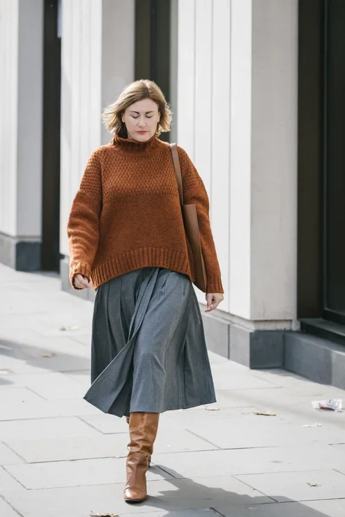 50 Thermal Layering Outfits for Cold January Days That Are Chic, Warm and Elegant 46 Grey Thermal Top under a Rust Knit Sweater with Grey Trousers and Tan Knee-high Boots