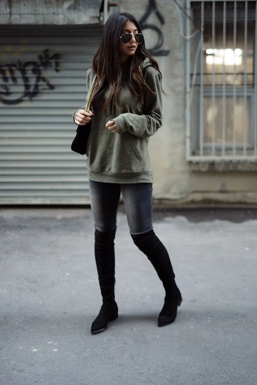 50 Thermal Layering Outfits for Cold January Days That Are Chic, Warm and Elegant 50 Black Thermal Top under a Olive Knit Sweater with Black Skinny Jeans and Black Knee-high Boots