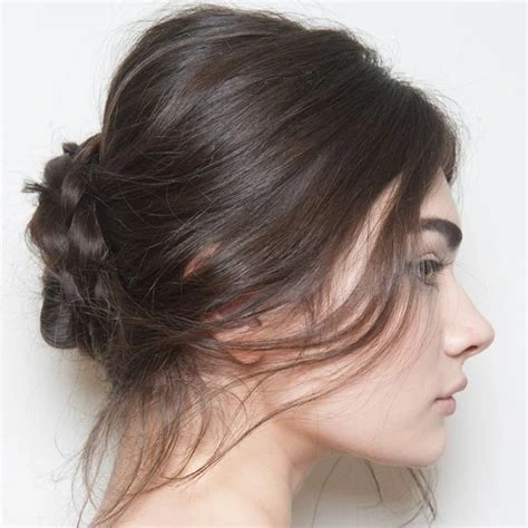 20 Winter Undone Texture Hairstyles For Women In Their 20s With A Messy Low Bun That Are Chic, Effortless and Cool 16 Undone Low Chignon With An Effortless Finish