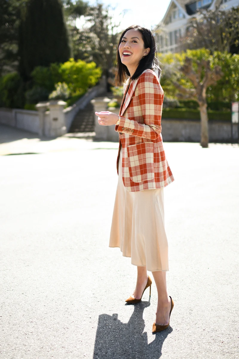 Rust check blazer with a cream midi dress