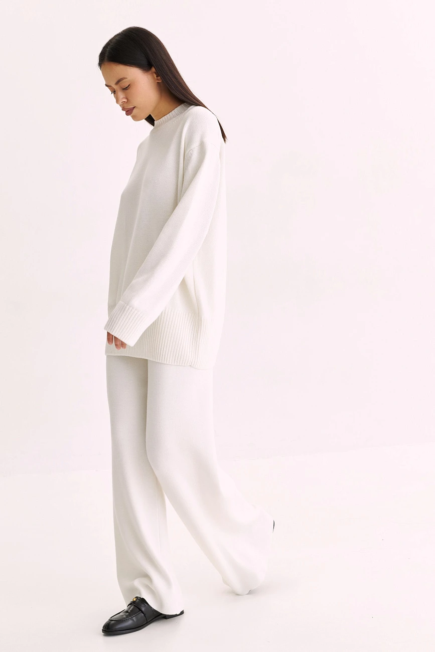 White thermal base layer, oversized sweater with wide-leg trousers and classic loafers