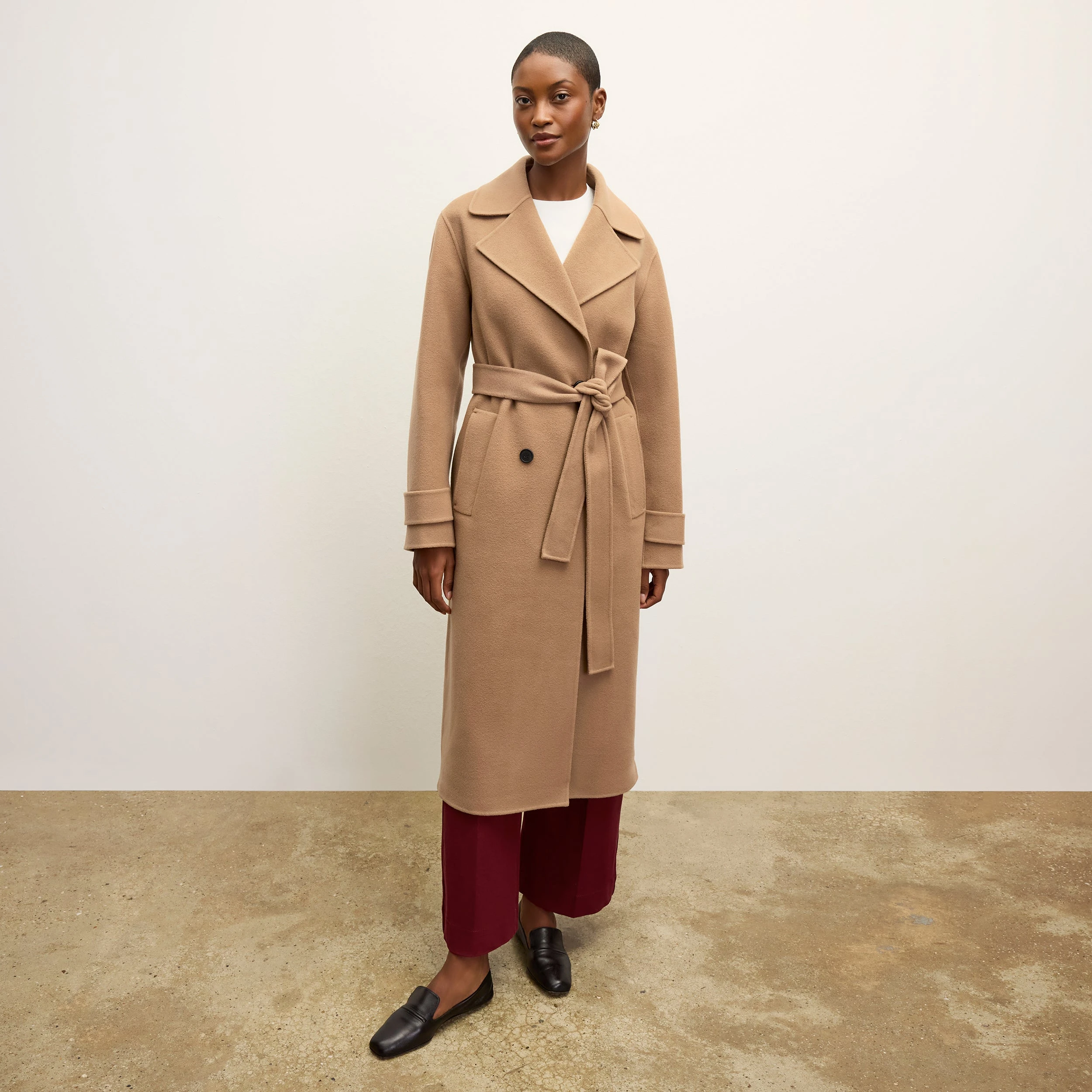 Camel Wool Coat with Burgundy Trousers and Black Shoes for a Late Office Evening