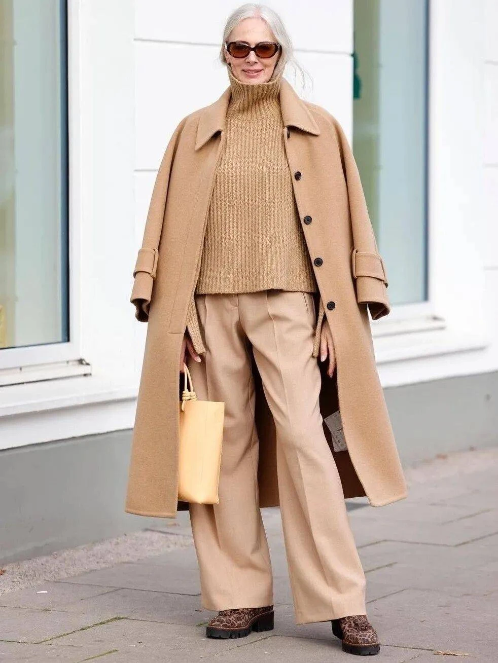 Camel Wool Coat with Beige Trousers and Leopard Shoes for a Tonal Office Look