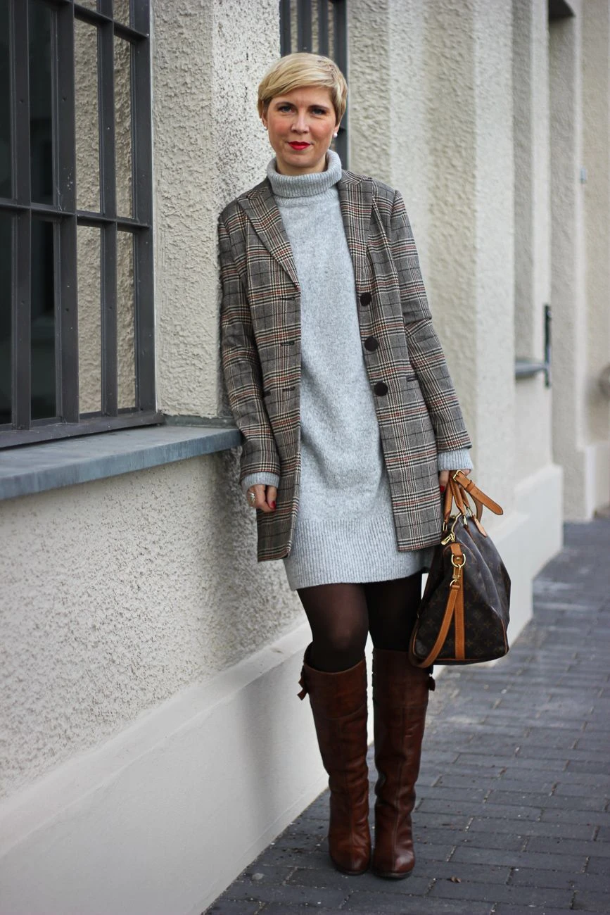 22 Checked Wool Coat Outfits for Women Over 40 for Winter Travel That Are Smart, Warm and Effortless 13 Checked Wool Coat with a Grey Dress and Brown Knee Boots for a Cosy Winter Break