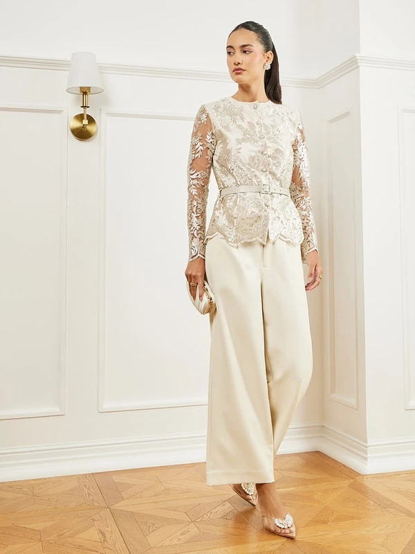 Ivory lace blouse and trouser outfit with pointed mules and a small structured clutch