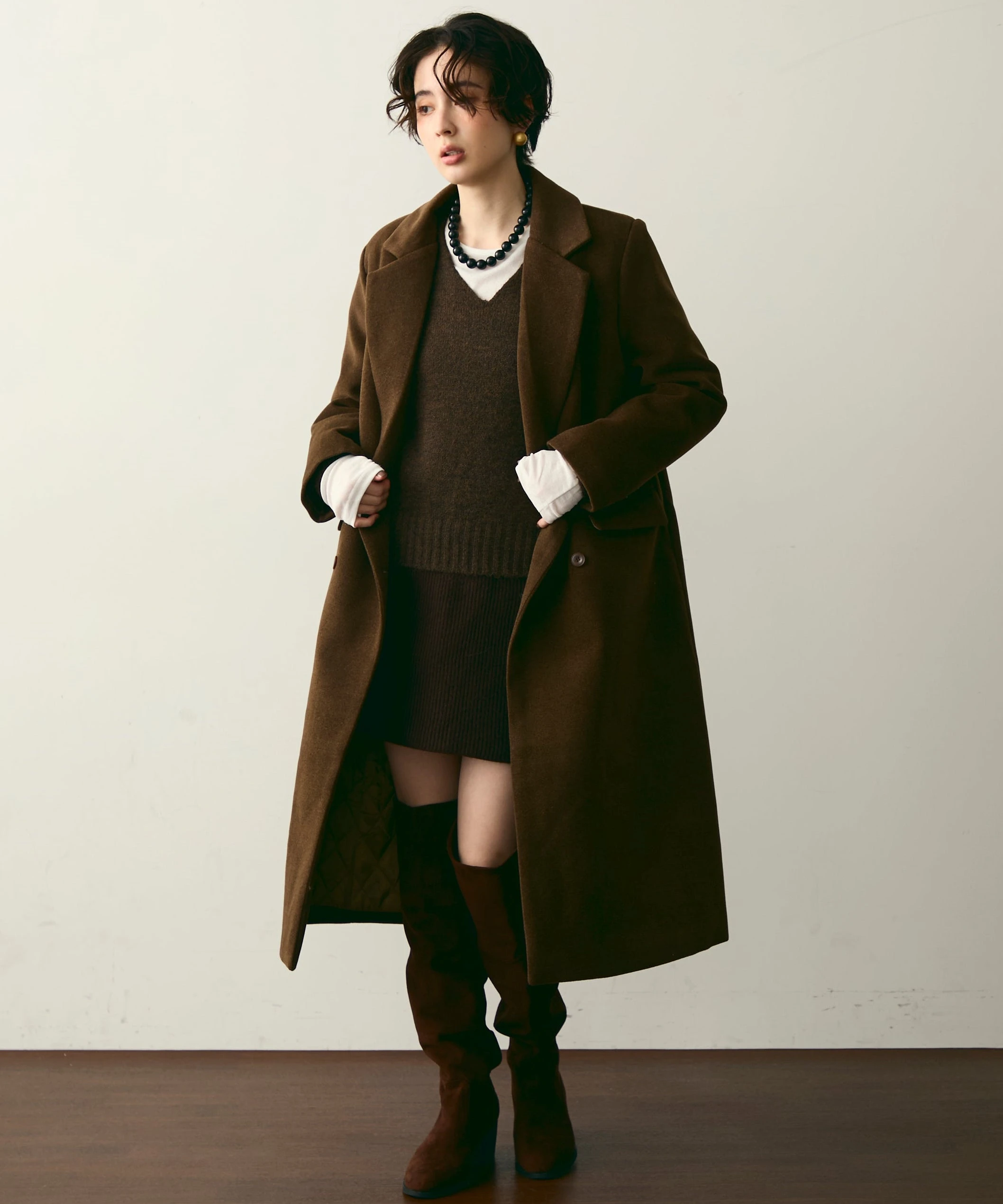 30 Long Wool Coat Outfits with Boots for Women Over 40 for Cold Walks That Are Warm, Smart and Effortless 28 Long Brown Wool Coat with a Brown Dress and Brown Knee Boots for a Warm Winter Walk