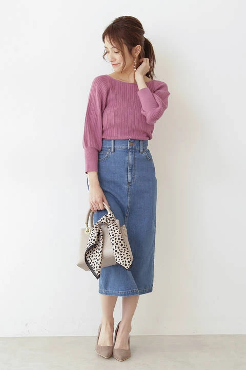 Pale pink sweater and denim skirt outfit with low-heeled pumps and a silk scarf