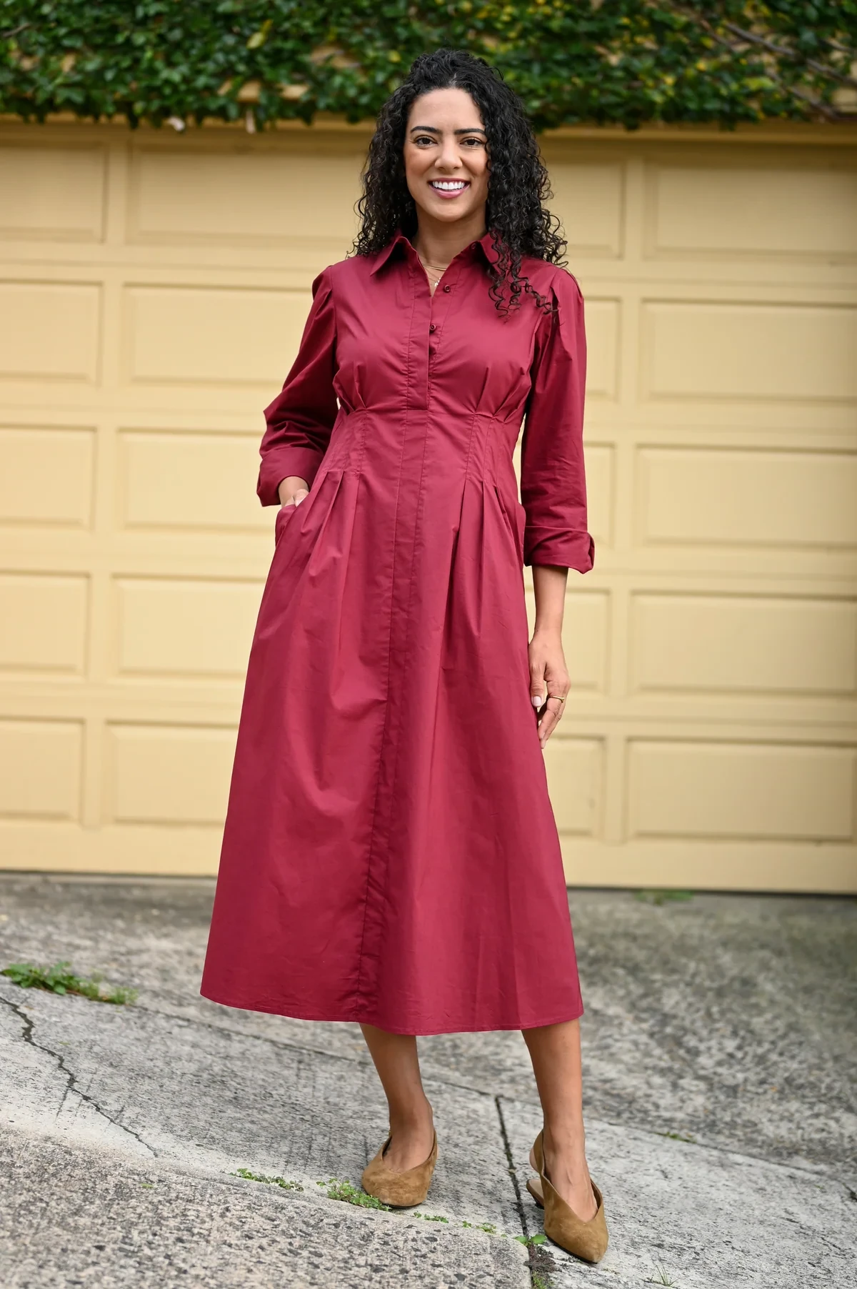 Wine shirt dress with low-heeled pumps and a delicate gold necklace
