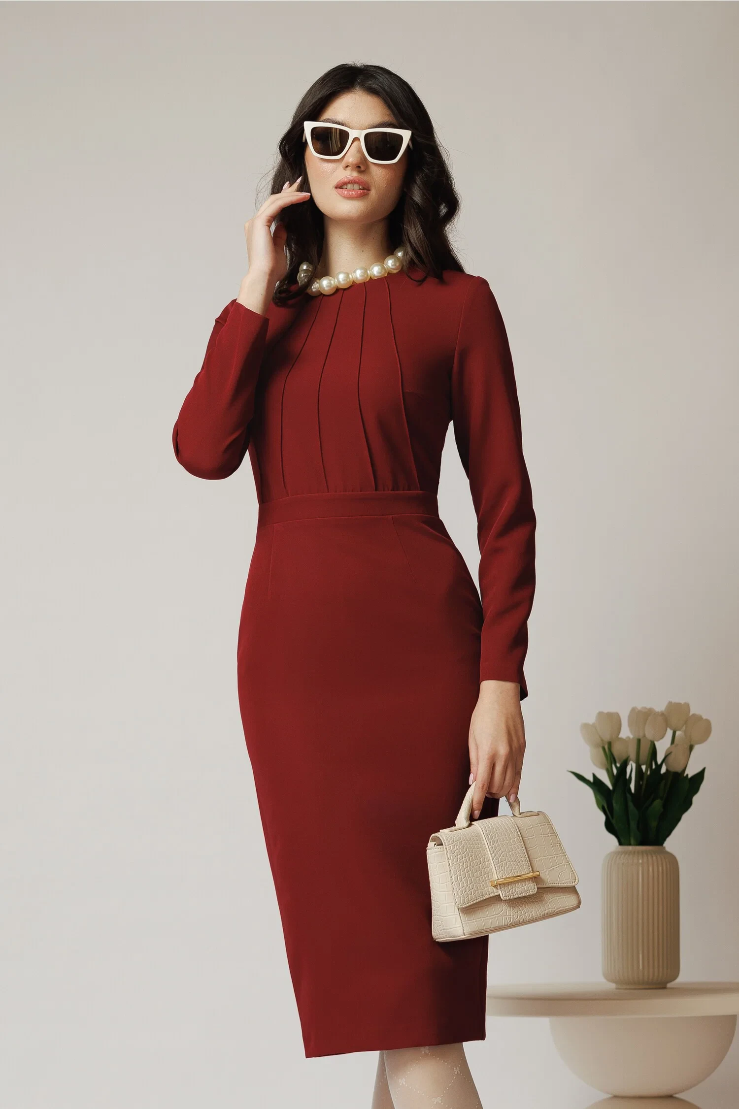 Scarlet long-sleeve dress with pointed mules and a pearl bracelet
