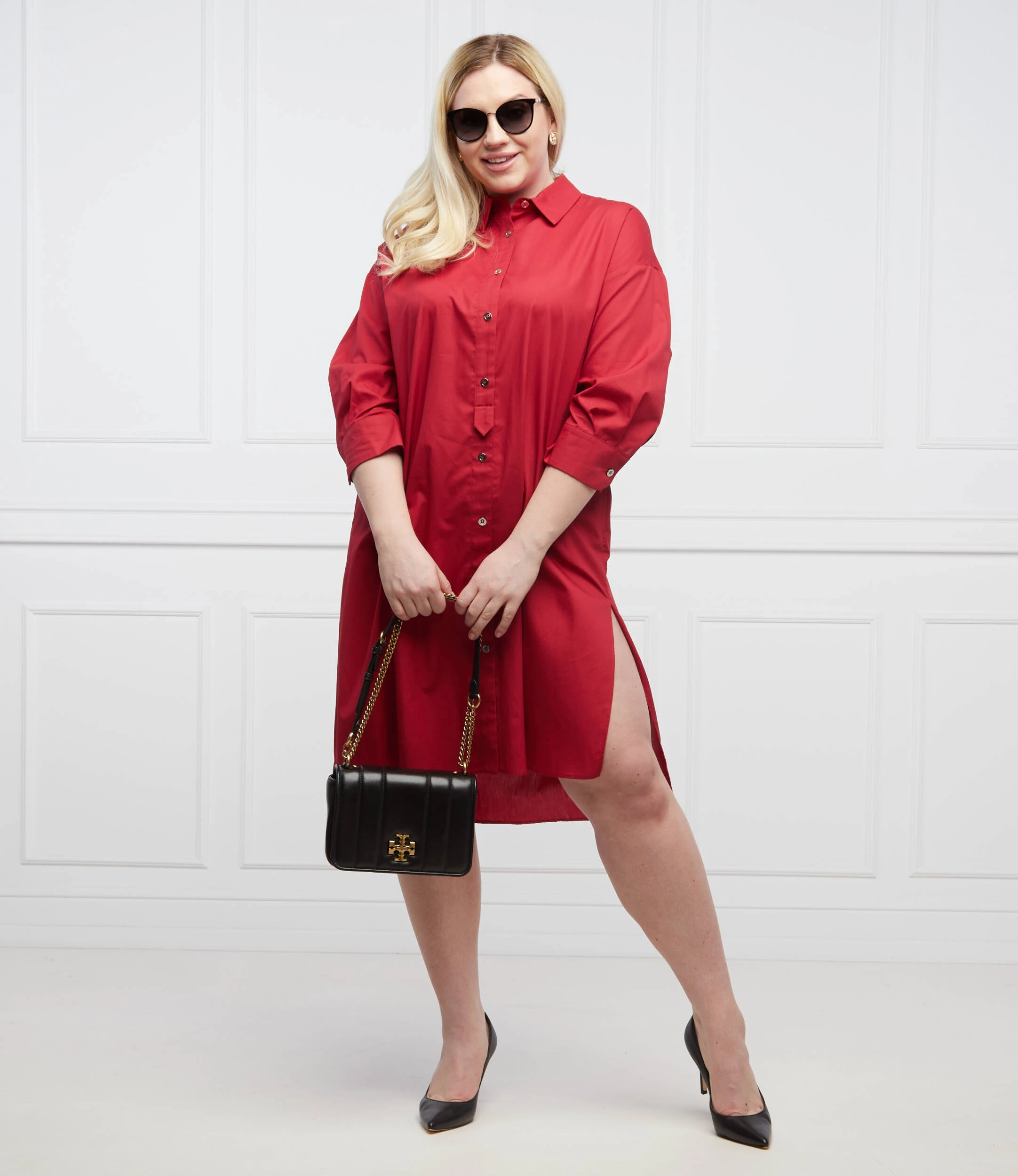 Bright red shirt dress with black pointed heels and a chic crossbody bag
