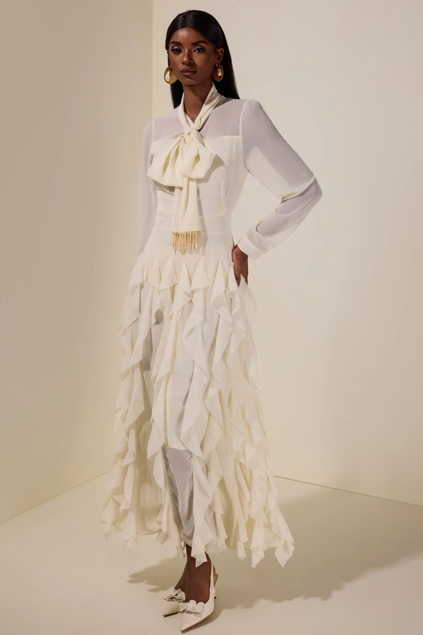 Ivory ruffle blouse and wrap skirt outfit with elegant pointed flats and statement earrings