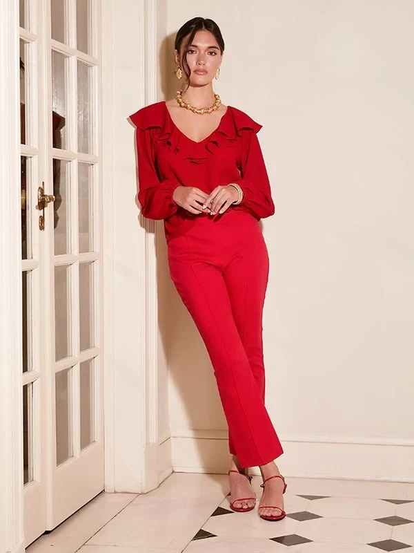 Red ruffle blouse and evening trouser outfit with kitten heels and a delicate gold necklace