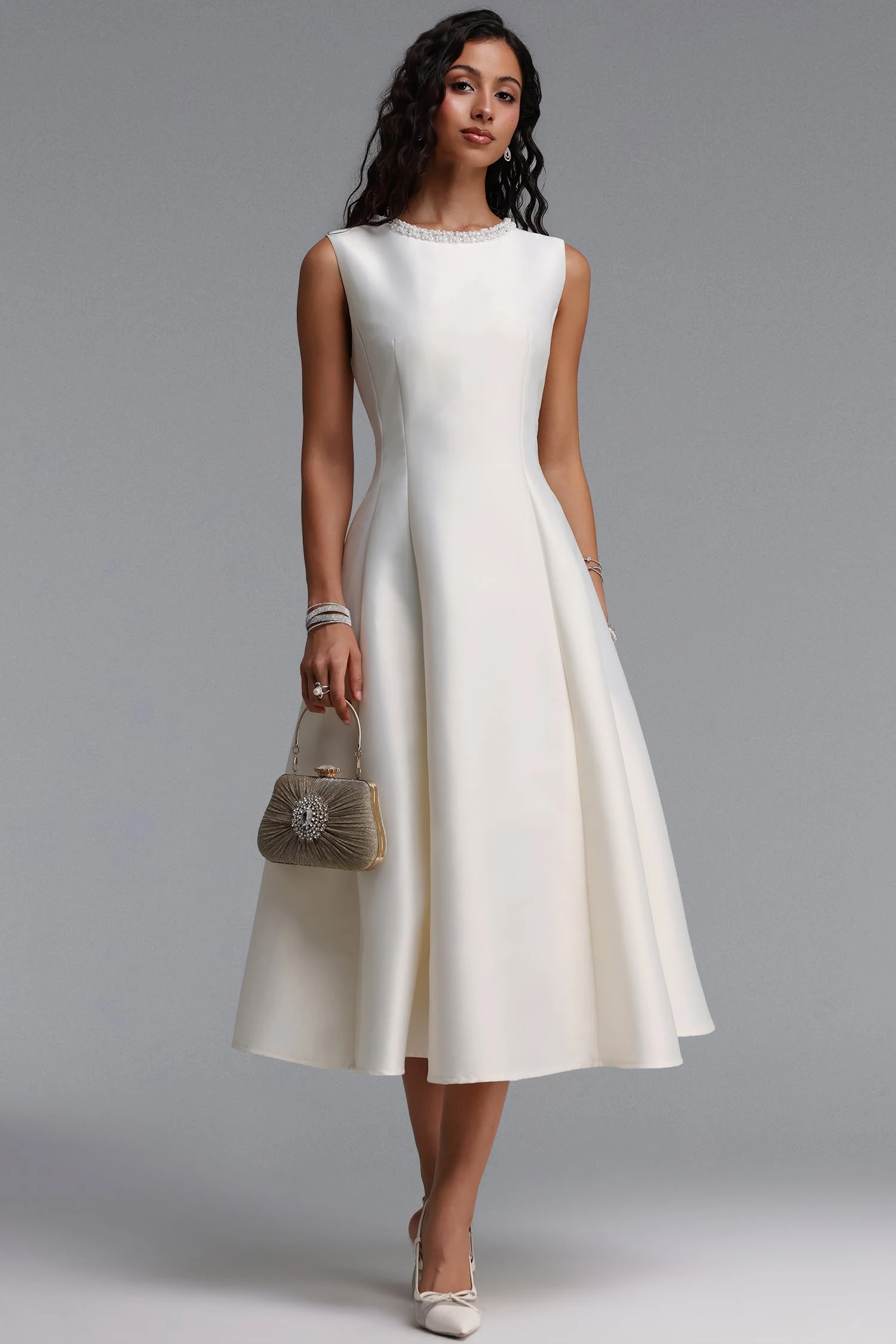 Ivory satin fit-and-flare dress with elegant pointed flats and a pearl bracelet