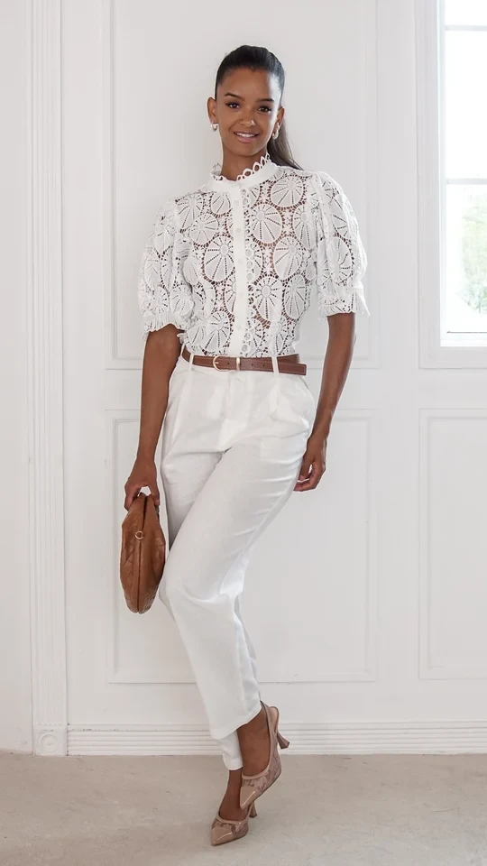 40 Women Over 50 Lace Blouse Outfits for Romantic Dinners That Are Chic, Romantic and Easy to Wear 22 White lace blouse and straight trouser outfit with low-heeled pumps and a chic crossbody bag