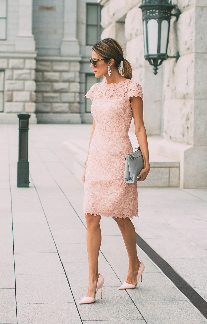 Blush lace fit-and-flare dress with low-heeled pumps and a chic crossbody bag