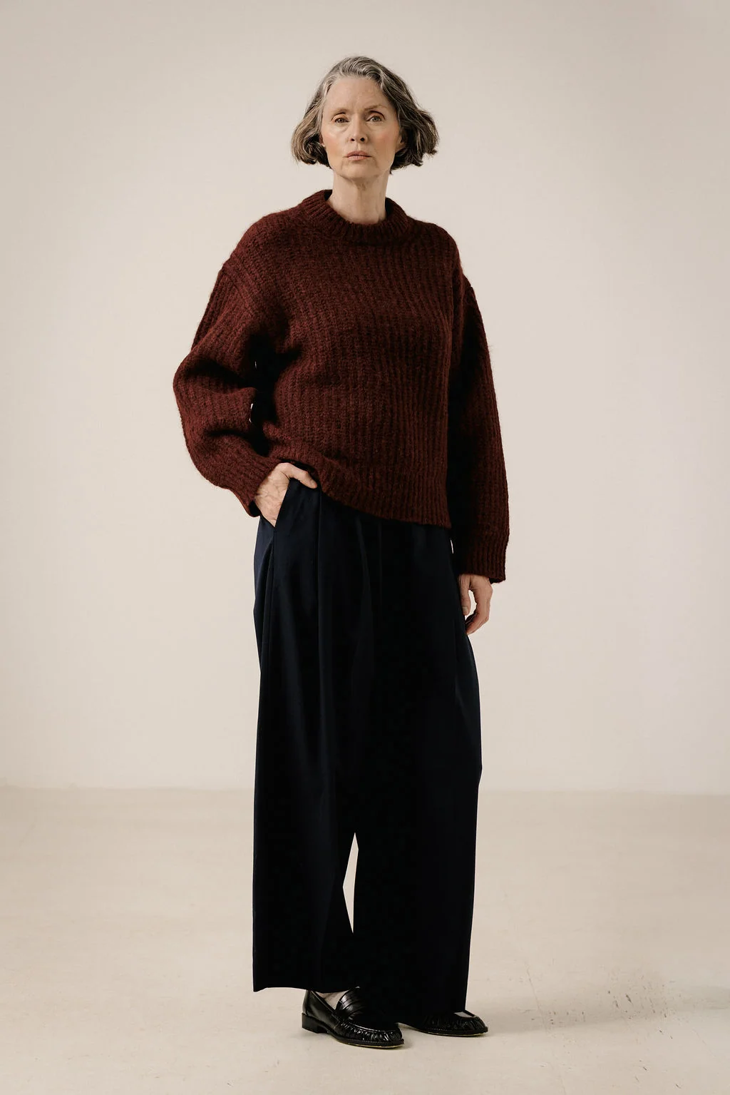25 Women over 50 thermal layering outfits for cold January days That Are Chic, Warm and Elegant 18 Burgundy thermal base layer, oversized sweater with wide-leg trousers and classic loafers